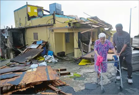  ?? CAROL GUZY VIA ZUMA WIRE ?? Rosa Maldonado, 87, is taken to a hospital Thursday after hunkering down for two days in a sweltering home in the La Perla neighborho­od in Old San Juan. She and her family waited inside when Hurricane Maria slammed into Puerto Rico on Tuesday.