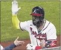  ?? TONY GUTIERREZ — THE ASSOCIATED PRESS ?? The Braves’ Marcell Ozuna celebrates after a home run against the Dodgers during the fourth inning in Game 4of a National League Championsh­ip Series game on Thursday in Arlington, Texas.