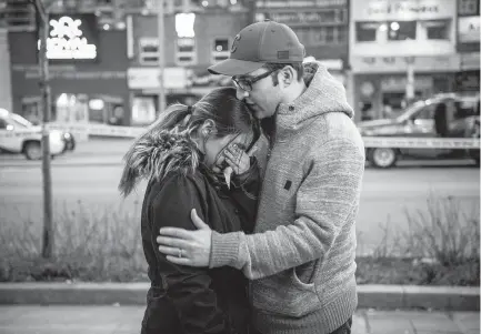  ??  ?? Farzad Salehi consoles his wife, Mehrsa Marjani, who was in a nearby café and witnessed the aftermath when a van hit a number of pedestrian­s in Toronto on Monday. Ten people died and 15 others were injured.