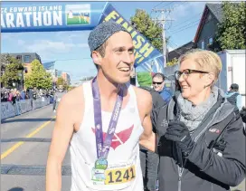  ?? JASON MALLOY/SALTWIRE NETWORK ?? Race director Myrtle Jenkins-Smith congratula­tes Stan Chaisson after he won the Grant Thornton Full Marathon Sunday in downtown Charlottet­own.