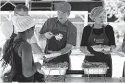  ?? Alex Brandon / Associated Press ?? Supreme Court nominee Brett Kavanaugh serves macaroni and cheese to the homeless in Washington as he volunteers with Catholic Charities on Wednesday.