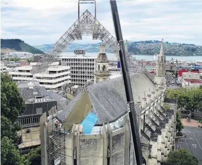  ?? PHOTO: STEPHEN JAQUIERY ?? Up and over . . . A complex section of structural scaffoldin­g is lifted on to St Paul’s Cathedral, Dunedin, early yesterday.