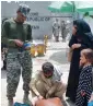  ?? APP ?? A security official is checking passports of an Afghan family at Torkham border on Sunday. —