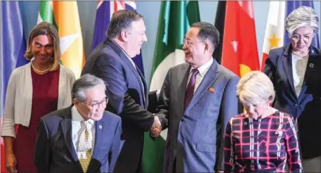  ?? MOHD RASFAN/AFP ?? US Secretary of State Mike Pompeo (third left) shakes hands with North Korea’s Foreign Minister Ri Yong-ho (third right) as they arrive for a group photo at the Asean Regional Forum Retreat during the 51st Associatio­n of Southeast Asian Nations Ministeria­l Meeting in Singapore on Saturday.