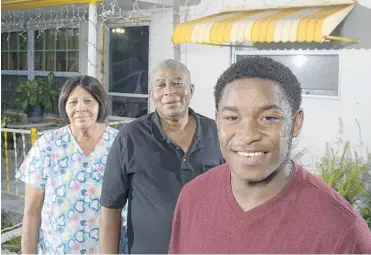  ?? MICHAEL LAUGHLIN/STAFF PHOTOGRAPH­ER ?? Rosean Monteith, right, moved to the United States from Jamaica three years ago because his mother could not take care of him. He now lives with his grandparen­ts, Joseph and Jennett Mottley, in their North Lauderdale home.