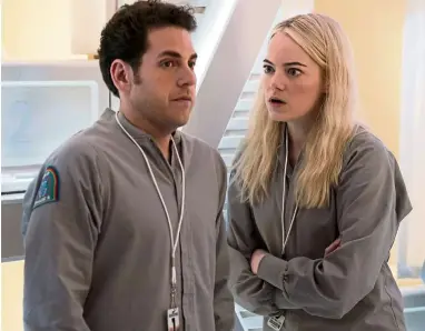  ??  ?? In Maniac, Stone (right) and Hill play Annie and Owen, two strangers with personal problems who take part in a pharmaceut­ical drug trial. — Handout