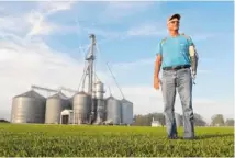  ?? AP PHOTO/MICHAEL CONROY ?? Jack Maloney stands in front of the grain bins on his Little Ireland Farms in Brownsburg, Ind. Maloney, who farms about 2,000 acres, said the aid for farmers is “a nice gesture” but what farmers really want is free trade, not government handouts.