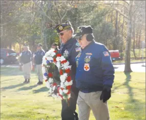  ?? Sloan Brewster / For Hearst Connecticu­t Media ?? Mike Rogalsky of the Middletown Council of Veterans and a chaplain carry a wreath to be laid during the Veterans Day ceremony at the the State Veterans Cemetery in Middletown.