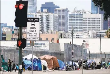  ?? Luis Sinco Los Angeles Times ?? U.S. CHIEF Justice John G. Roberts Jr. questioned why judges or the justices, rather than city officials, should decide how to cope with the problem of homelessne­ss. Above, on 5th Street in downtown Los Angeles last year.