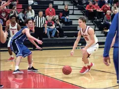  ?? Photos by TIM GODBEE / For the Calhoun Times ?? ( Sonoravill­e’s Wil Walraven (right) drives toward the lane during the second half on Monday. ( Sonoravill­e’s Lucas Brooks (right) goes up for a shot over a Model defender.