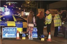  ?? PETER BYRNE/PA VIA AP ?? Police work at Manchester Arena after reports of an explosion at the venue during an Ariana Grande gig in Manchester, England on Monday.