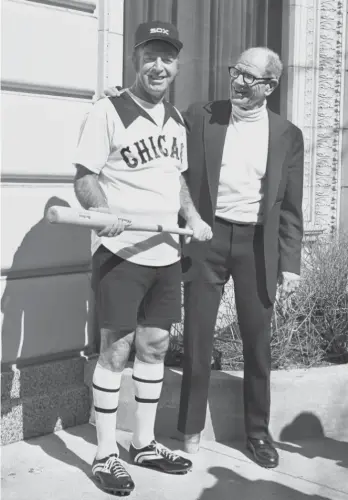  ?? AP ?? Former White Sox owner Bill Veeck presents ex-major-leaguer Jim Rivera in the team’s unique hot-weather uniform for the 1976 season. The getup was as gimmicky as the DH rule instituted three years earlier.