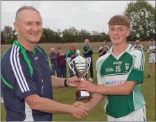  ??  ?? Avondale captain Zach Cullen accepting the trophy from Hugh Kenny.