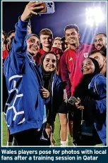  ?? ?? Wales players pose for photos with local fans after a training session in Qatar