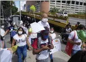  ?? ?? Joshue Acevedo, a 4-year-old with leukemia, is carried by his father during a protest for the reactivati­on of the organ transplant program in Caracas, Venezuela. Joshue died on Oct. 26 while waiting for a bone-marrow transplant.