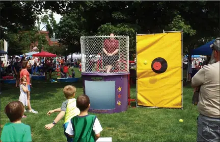 ?? TYLER RIGG — THE NEWS-HERALD ?? Kids take shots at a dunk tank in an attempt to soak their school teachers during Chardon KidsFest, Aug. 1.