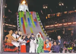  ?? KIRSTY WIGGLESWOR­TH/THE ASSOCIATED PRESS ?? Athletes from various nations including Pita Taufatofua, of Tonga, at left, United States’ Lindsey Vonn, third from left, and Thomas Bach, president of the Internatio­nal Olympic Committee, fifth from left, pose Sunday during the closing ceremony of the Winter Olympics.