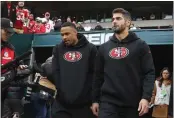  ?? KARL MONDON — BAY AREA NEWS GROUP FILE ?? Injured San Francisco 49ers quarterbac­k Jimmy Garoppolo, right, enters the field before the NFC Championsh­ip game Sunday, Jan. 29, in Philadelph­ia.