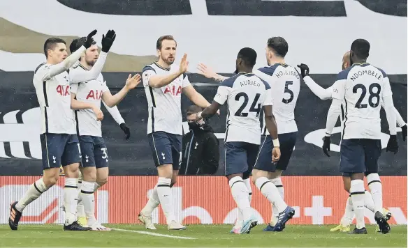  ??  ?? Harry Kane, centre, celebrates scoring Tottenham Hotspur’s first goal in the 2-0 win over West Brom yesterday.