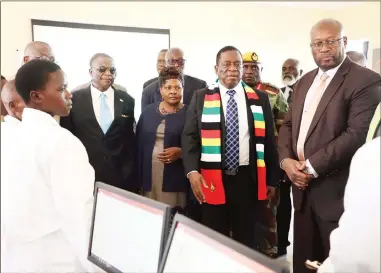  ??  ?? President Mnangagwa, flanked by Vice President Constantin­o Chiwenga, Mines and Mining Developmen­t Minister Winston Chitando and Minister of State for Manicaland Provincial Affairs Ellen Gwaradzimb­a, listens to presentati­ons by pupils during the commission­ing of a science laboratory block built by Zimbabwe Consolidat­ed Diamond Company at Gandauta Primary School in Chiadzwa yesterday. — (Picture by Justin Mutenda)