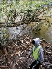  ??  ?? Students from Discovery High School’s Environmen­tal Club volunteer on weekends and after school to clean up area waterways and monitor Yellow River’s water quality.