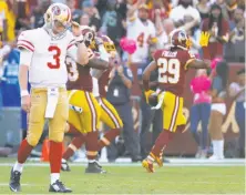  ?? Alex Brandon / Associated Press ?? Quarterbac­k C.J. Beathard leaves the field as Washington’s Kendall Fuller (29) celebrates his game-clinching intercepti­on.