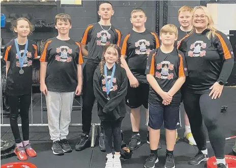  ?? ?? The successful young weightlift­ers from Weights & Cakes with coach Zoe Chandler.