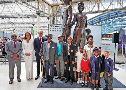  ?? ?? Landmark day: William and Kate in front of the 12ft statue with Windrush pioneers, schoolchil­dren and Dame Floella Benjamin