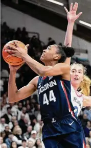  ?? Laurence Kesterson/Associated Press ?? UConn forward Aubrey Griffin (44) moves around Villanova’s Lucy Olsen during the first half Saturday in Villanova, Pa.