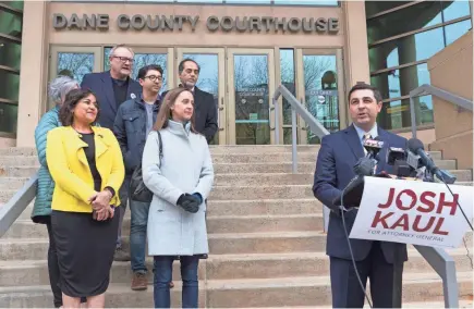  ?? MARK HOFFMAN/MILWAUKEE JOURNAL SENTINEL ?? Democrat Josh Kaul (right) claims victory Wednesday in the attorney general's race during a news conference at the Dane County Courthouse in Madison.