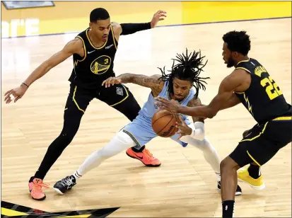  ?? KARL MONDON — BAY AREA NEWS GROUP ?? The Memphis Grizzlies' Ja Morant battles for the ball while defended by the Golden State Warriors' Jordan Poole and Andrew Wiggins in the fourth quarter of Game 3of a second-round playoff series at Chase Center in San Francisco on Saturday.