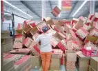  ?? — Reuters ?? An employee works at an Alibaba Tmall logistics centre in Suzhou, China.