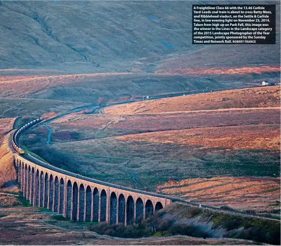  ?? ROBERT FRANCE ?? A Freightlin­er Class 66 with the 13.46 Carlisle Yard-Leeds coal train is about to cross Batty Moss, and Ribblehead viaduct, on the Settle & Carlisle line, in low evening light on November 23, 2014. Taken from high up on Park Fell, this image was the winner in the Lines in the Landscape category of the 2015 Landscape Photograph­er of the Year competitio­n, jointly sponsored by the Sunday Times and Network Rail.