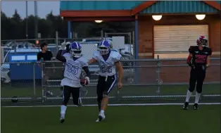  ?? NEWS PHOTO JAMES TUBB ?? Crescent Heights Vikings running back Abdul Kiawen points to the sky while quarterbac­k Carter MacLean pats him on the back after scoring one of his two touchdowns in the Vikings 33-3 win Thursday night against the McCoy Colts. The Vikings and Colts met at the Methanex Bowl in the second annual Rick Boksteyn memorial bowl to kickoff the RFC season.