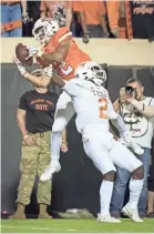  ?? ROB FERGUSON/USA TODAY SPORTS ?? Oklahoma State wide receiver Tylan Wallace makes a catch while defended by Texas defensive back Brandon Jones.