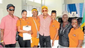  ?? NATHANIEL STEWART/PHOTOGRAPH­ER ?? Independen­t candidate Uphel Purcell (centre) with his supporters following his nomination to contest the York Town division in Clarendon South Western on Thursday.