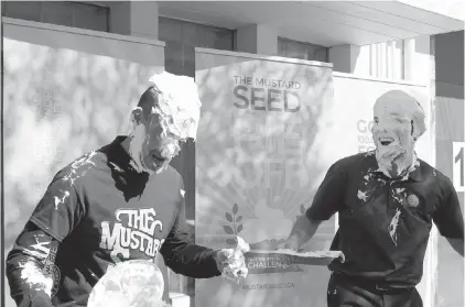  ??  ?? Allan Lingwood, left, director of developmen­t for the Mustard Seed, and Christophe­r Mazrikof, executive director of the Dahlia Society, kicked off national hunger awareness week with the annual Pie Off Challenge on Wednesday.