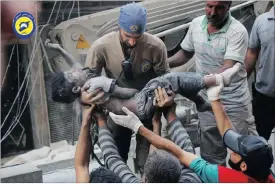  ?? Pictures: AP ?? A Civil Defence worker carries the body of a child after air strikes hit al-Shaar neighbourh­ood in Aleppo, Syria. Without hope for the future, no regular schooling and little access to nutritious food, the children of Aleppo and their parents struggle...