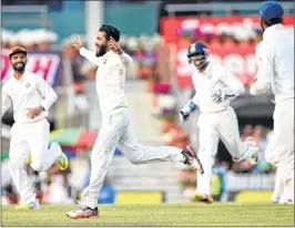  ??  ?? Ravindra Jadeja (2L) celebrates with teammates after he dismissed unseen batsman Nathan Lyon during fourth day’s play at the JSCA Stadium in Ranchi on Sunday.