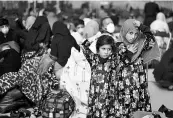  ?? PHOTO: AP/PTI ?? Two girls from Afghanista­n wait with other evacuees inside a hanger at the US Air Base in Ramstein, Germany.