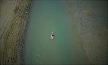  ?? AP PHOTO/ DANIEL COLE ?? In 2022, a paddle boarder passes through a drying portion of the Verdon Gorge in southern France.