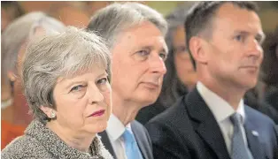  ??  ?? Mrs May, Chancellor Philip Hammond and Health Secretary Jeremy Hunt yesterday