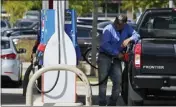  ?? NAM Y. HUH — THE ASSOCIATED PRESS ?? A man fuels his truck at a gas station Sept. 13in Palatine, Ill. Higher longer-term interest rates coincide with other threats to economic growth, such as higher gas prices.