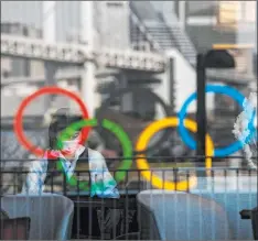  ?? Jae C. Hong The Associated Press ?? Tokyo is bracing for the Olympics, as the familiar rings suggest, but the slow vaccine rollout in Japan is a huge concern for officials.