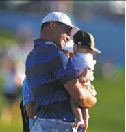  ?? Matt Sullivan / Getty Images ?? Gary Woodland holds his son, Jaxson Lynn, after winning the Phoenix Open at TPC Scottsdale.
