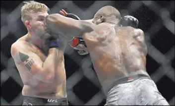  ?? Kyusung Gong The Associated Press ?? Jon Jones lands an elbow to Alexander Gustafsson during their UFC 232 light heavyweigh­t title bout Saturday in Inglewood, Calif. Jones claimed the belt for the third time with a third-round knockout.