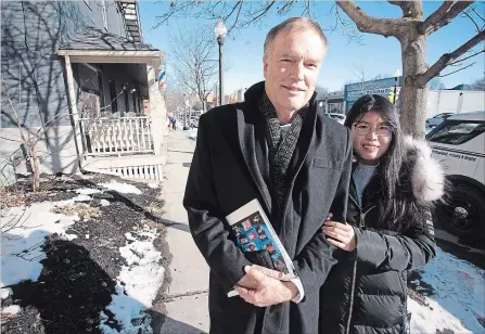  ?? JASON BAIN EXAMINER ?? John Hucks, seen with Trent University graduate student Shengnan (Wendy) Kang on Hunter Street East, has been working to connect internatio­nal students with the local business community