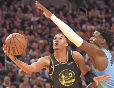  ?? JOE RONDONE/THE COMMERCIAL APPEAL ?? Grizzlies forward Jaren Jackson Jr. defends Warriors guard Jordan Poole during Game 3 of the second round of the NBA playoffs on Saturday at Chase Center.