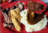  ?? Arkansas Democrat-Gazette/ROSEMARY BOGGS ?? A sampler platter at Nashville Rockin’ Grill in North Little Rock comes with pulled pork, brisket, catfish, two sides and a tamale (not pictured).
