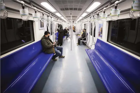  ?? (AP) ?? In this file photo, commuters ride in a quiet subway train during the morning rush hour in Beijing. As many Chinese finally go back to work after their longest Lunar New Year holiday ever, the economic fallout from the outbreak of a new coronaviru­s that began in Wuhan may be just beginning. Companies are warning their bottom lines will take a hit, and government­s are ramping up
stimulus measures for economies that just weeks ago were hoping to see recoveries after months of uncertaint­y due to trade tensions and slowing global growth.